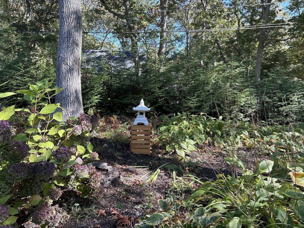 26 Highland Street Mashpee, MA 02649 - Photo 17 of 20 a backyard of a house with a yard with outdoor seating
