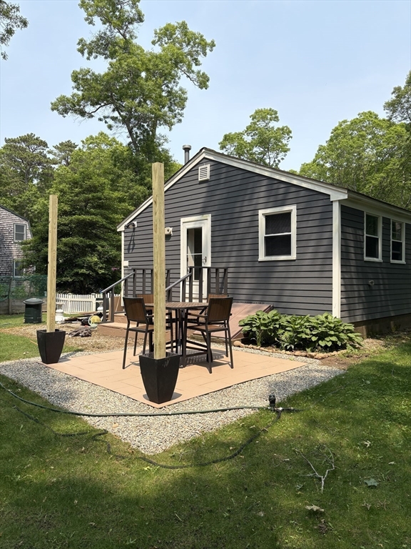 26 Highland Street Mashpee, MA 02649 - Photo 2 of 20 a view of a house with yard and sitting area