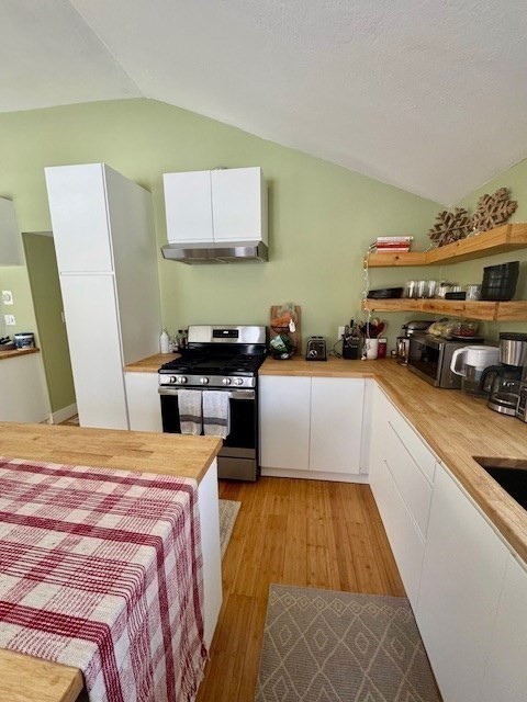 26 Highland Street Mashpee, MA 02649 - Photo 7 of 20 a kitchen with stainless steel appliances a sink a stove top oven a counter space and cabinets