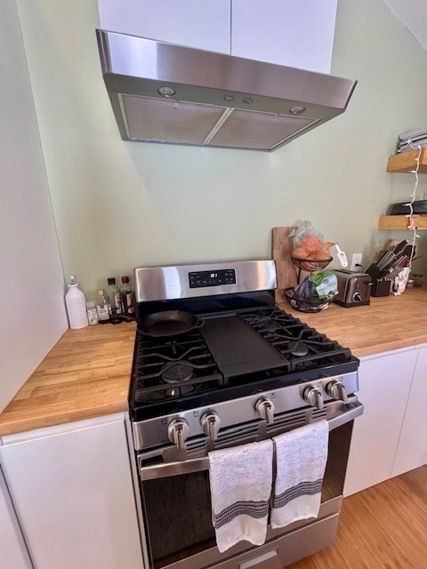 26 Highland Street Mashpee, MA 02649 - Photo 9 of 20 a stove top oven sitting inside of a kitchen