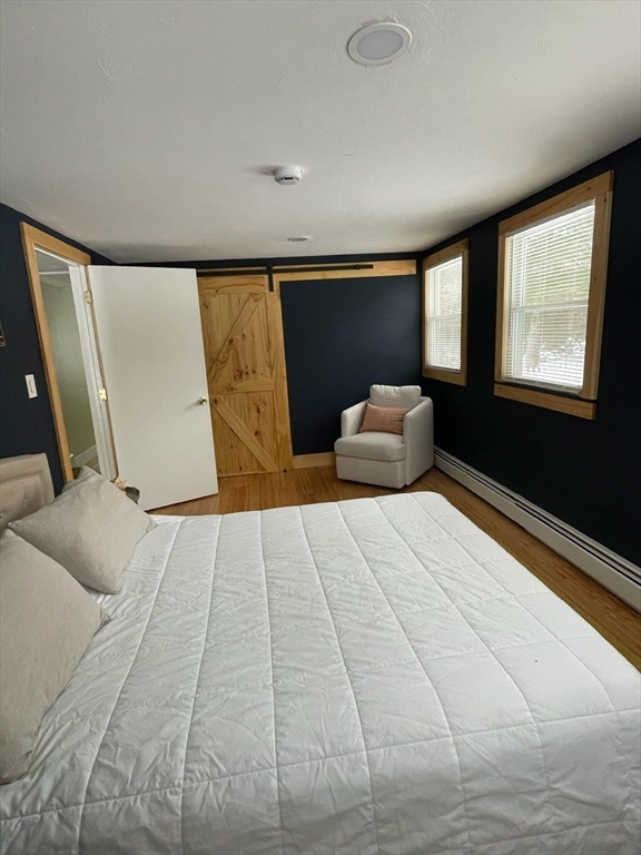 26 Highland Street Mashpee, MA 02649 - Photo 10 of 20 a bedroom with a bed and window