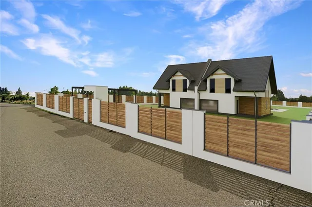 a view of a house with a wooden fence