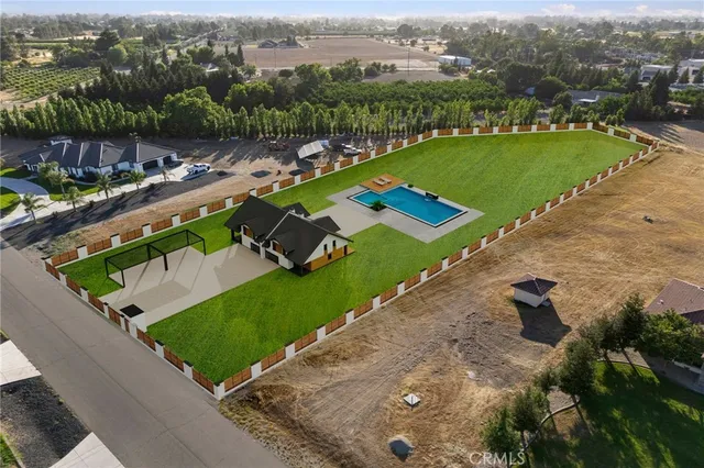 an aerial view of a house with a garden and lake view