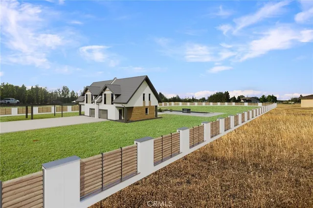 a view of a house with backyard and garden