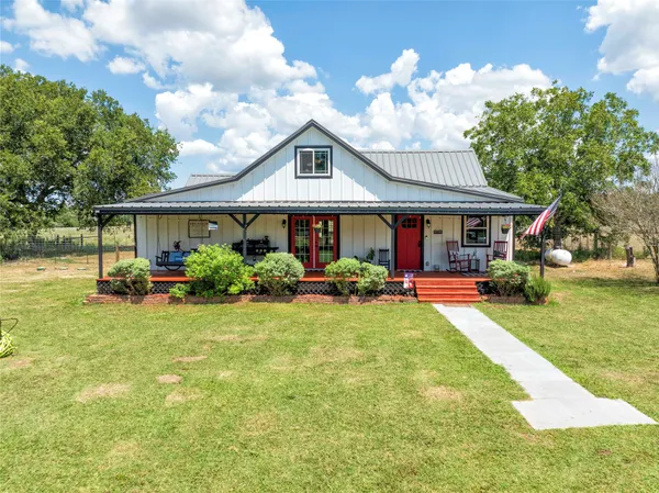 a front view of a house with yard porch and furniture