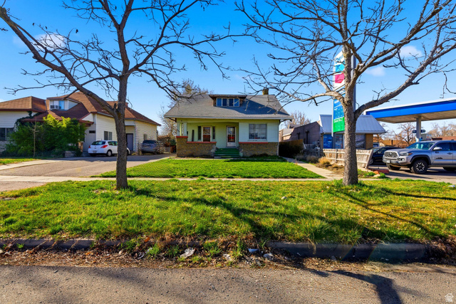 869 West Center Street Provo, UT 84601 - Photo 3 of 32 Bungalow featuring brick siding, a front lawn, and a chimney
