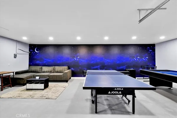a living room with furniture and a painting on the wall