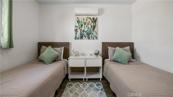 a kitchen with stainless steel appliances granite countertop a dining table chairs refrigerator and cabinets