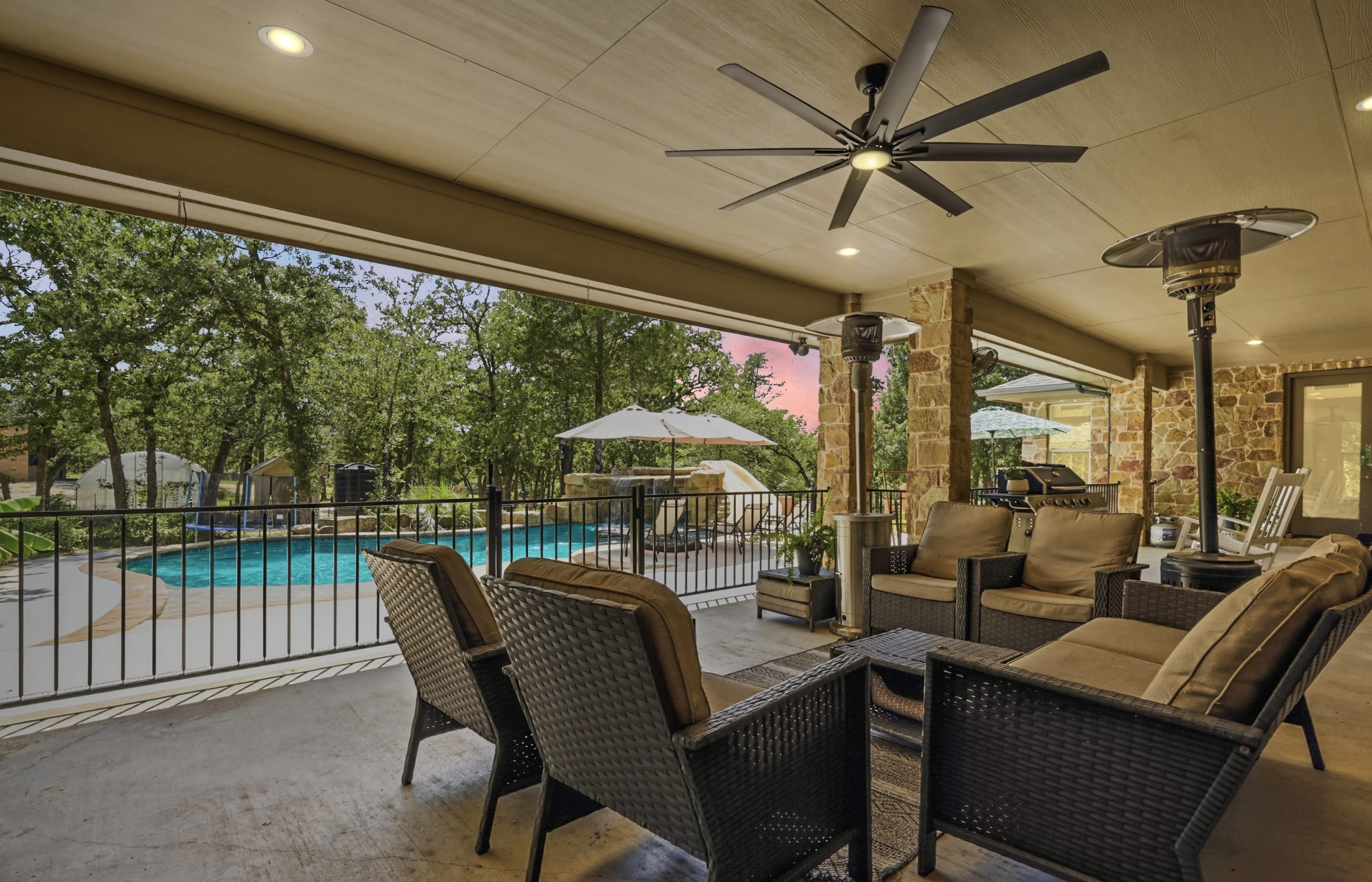 387 Corral Road Smithville, TX 78957 - Photo 30 of 40 Covered patio featuring stone columns, recessed lighting, and a ceiling fan