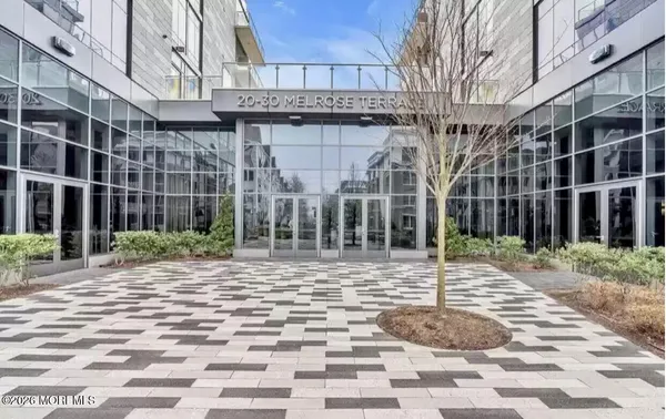 a view of a brick building with a bench in front of it