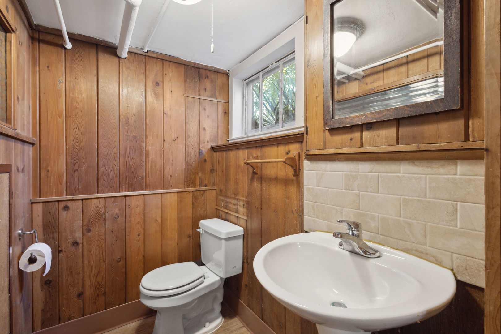 310 Bartram Road Riverside, IL 60546 - Photo 12 of 25 a bathroom with a sink a toilet and a mirror