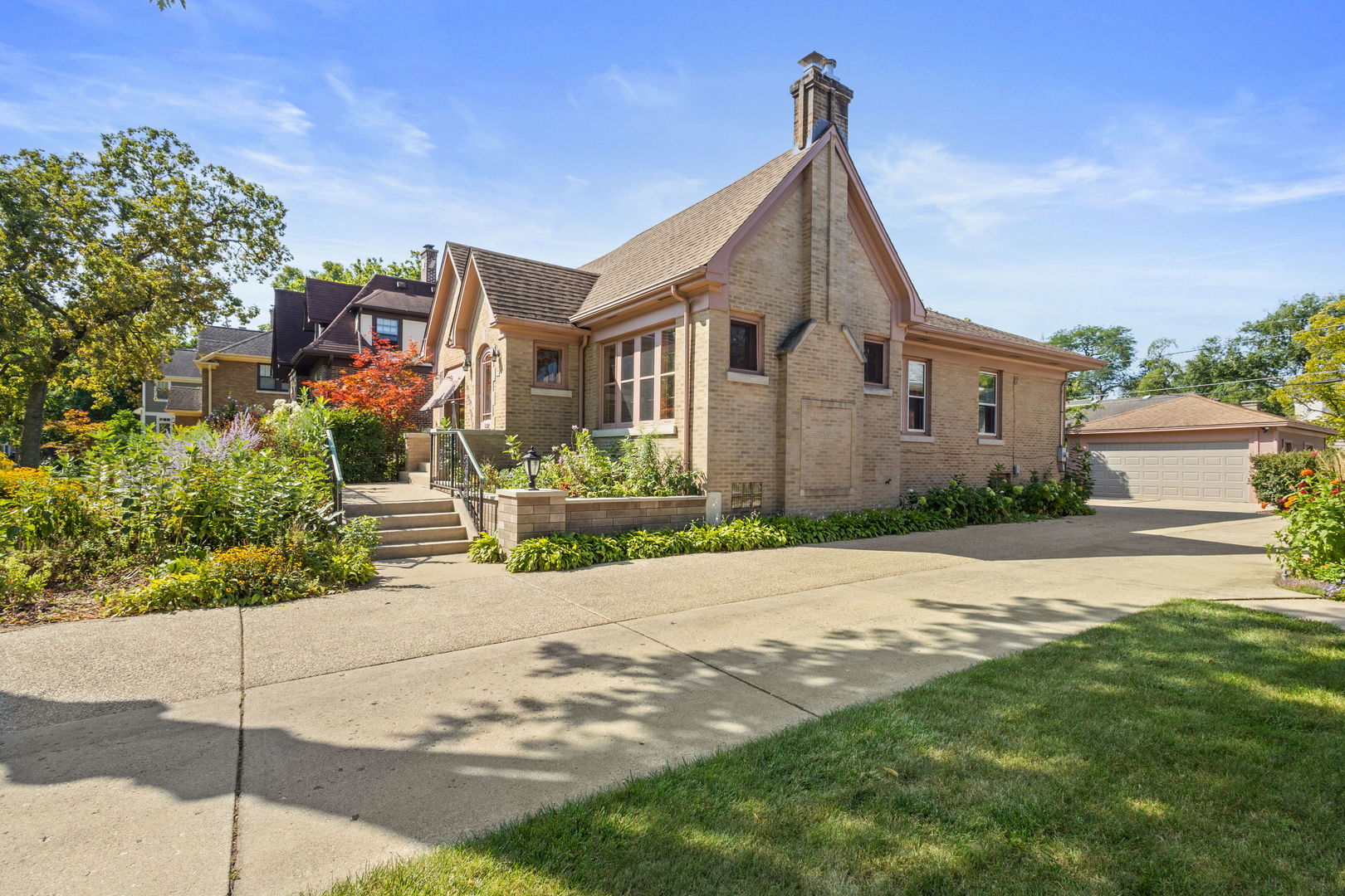 310 Bartram Road Riverside, IL 60546 - Photo 16 of 25 a front view of a house with a yard and garage