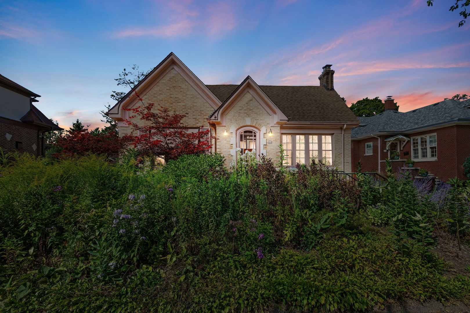 310 Bartram Road Riverside, IL 60546 - Photo 17 of 25 a front view of a house with a garden