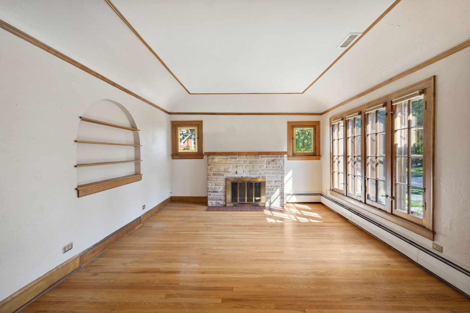 310 Bartram Road Riverside, IL 60546 - Photo 2 of 25 a view of an empty room with a fireplace and a window