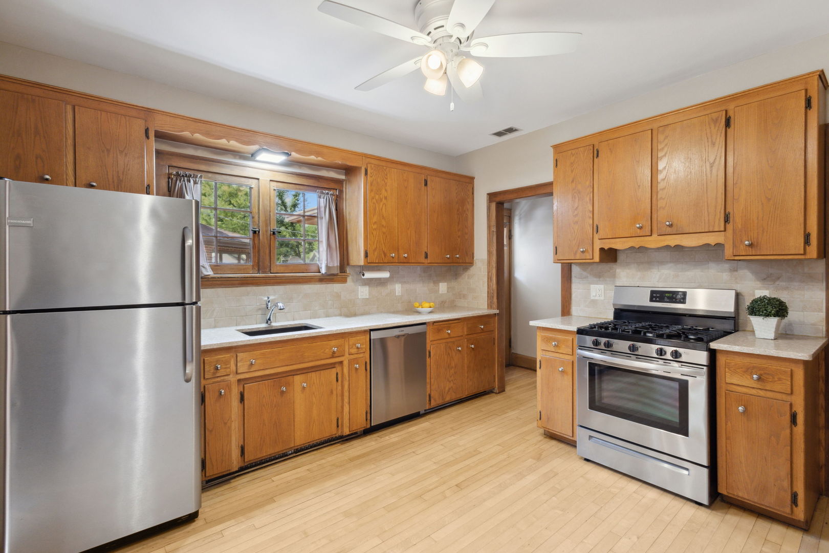 310 Bartram Road Riverside, IL 60546 - Photo 5 of 25 a kitchen with stainless steel appliances granite countertop a stove a refrigerator and a sink