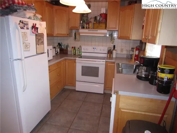 a kitchen with a refrigerator a stove a microwave and cabinets