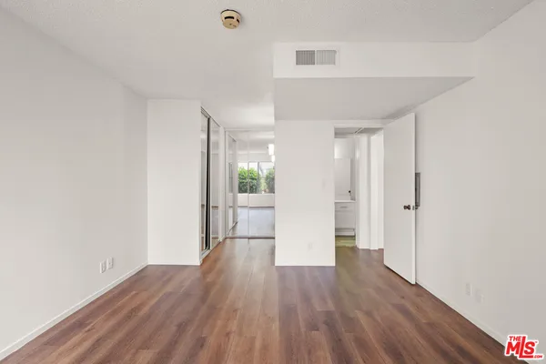 a view of a room with wooden floor