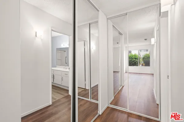 a view of a hallway with wooden floor