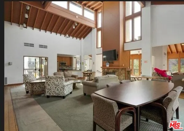a living room with fireplace furniture and a large window