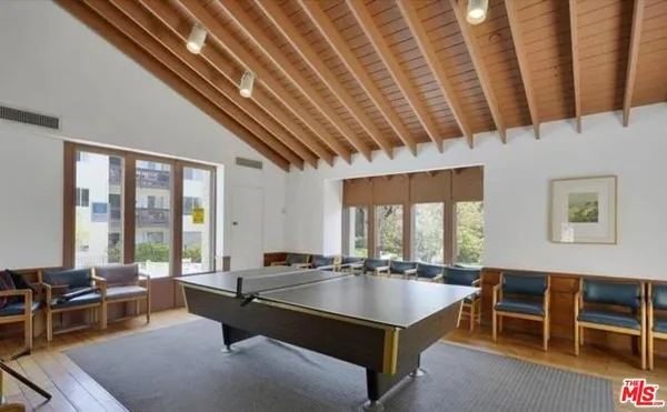 a living room with furniture pool table table and chairs