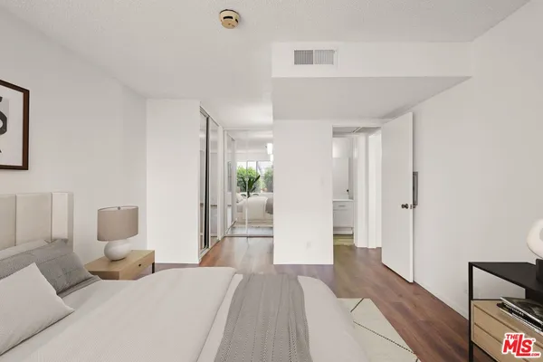 a bedroom with furniture and a wooden floor