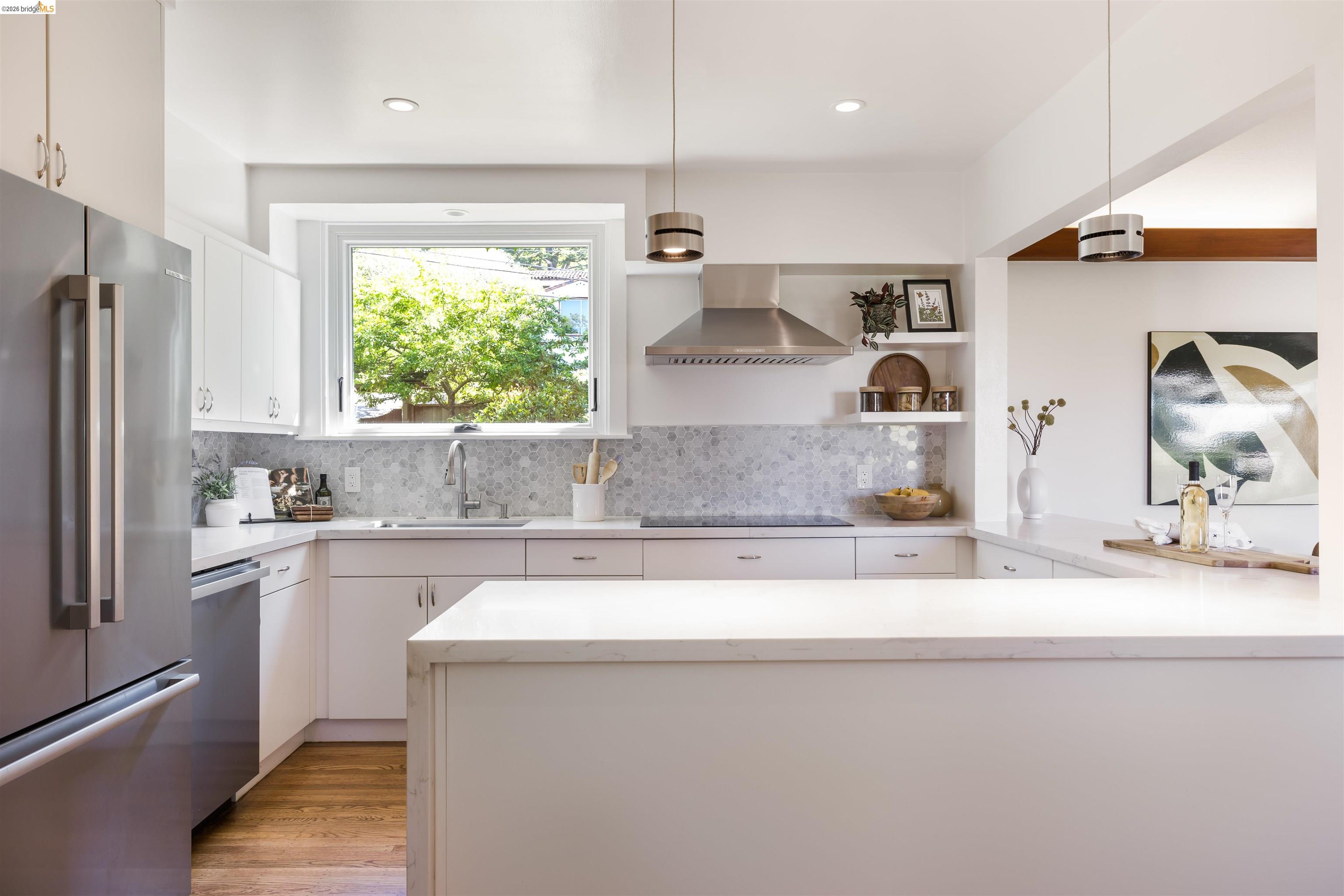 900 Euclid Avenue Berkeley, CA 94708 - Photo 13 of 54 a kitchen with stainless steel appliances granite countertop a sink a microwave a refrigerator and white cabinets