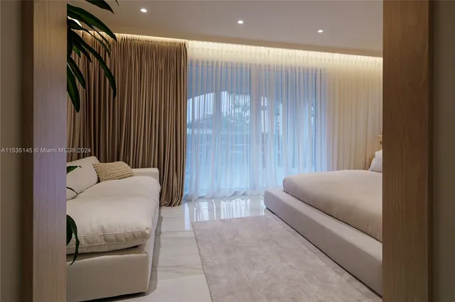 a living room with furniture and a balcony