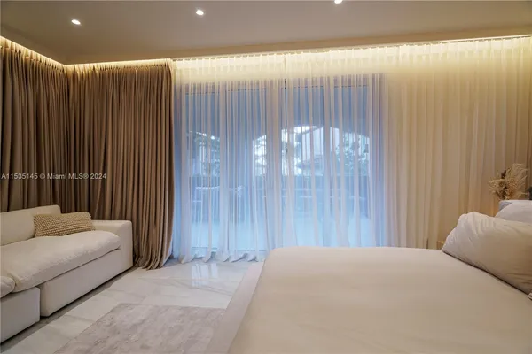 a bedroom with a bed and a couch