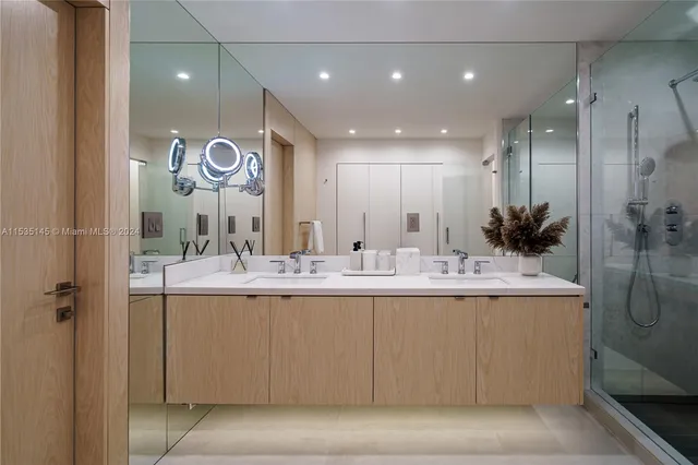 a bathroom with a granite countertop sink a large mirror and shower