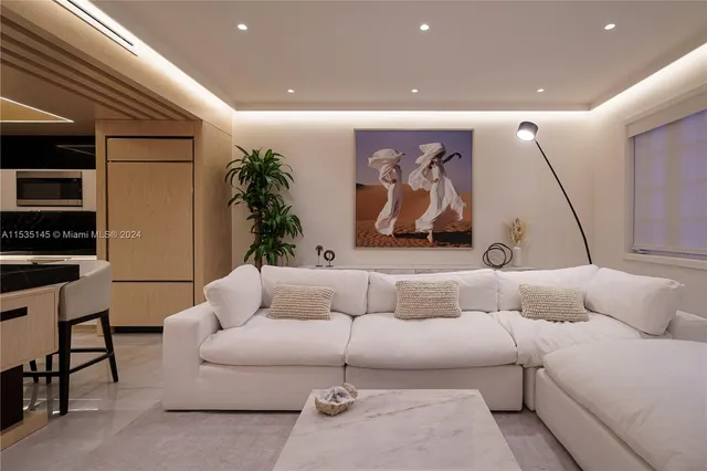 a living room with furniture and wall paintings