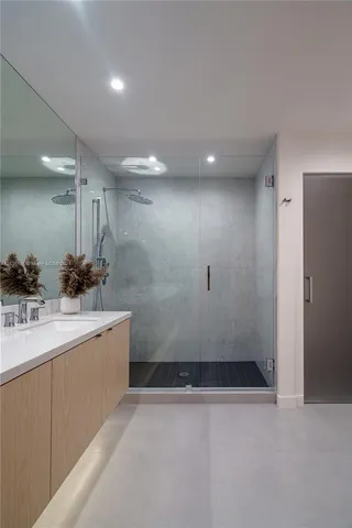 a view of a kitchen with a sink and a refrigerator