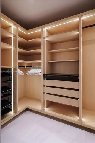 a view of walk in closet with empty racks