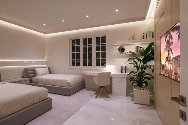 a bedroom with two beds and a potted plant