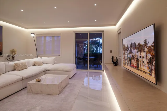 a living room with furniture and wall paintings