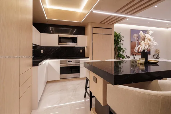 a kitchen with a sink stainless steel appliances and cabinets