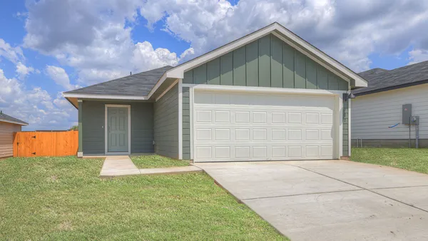 a front view of house with garage and yard
