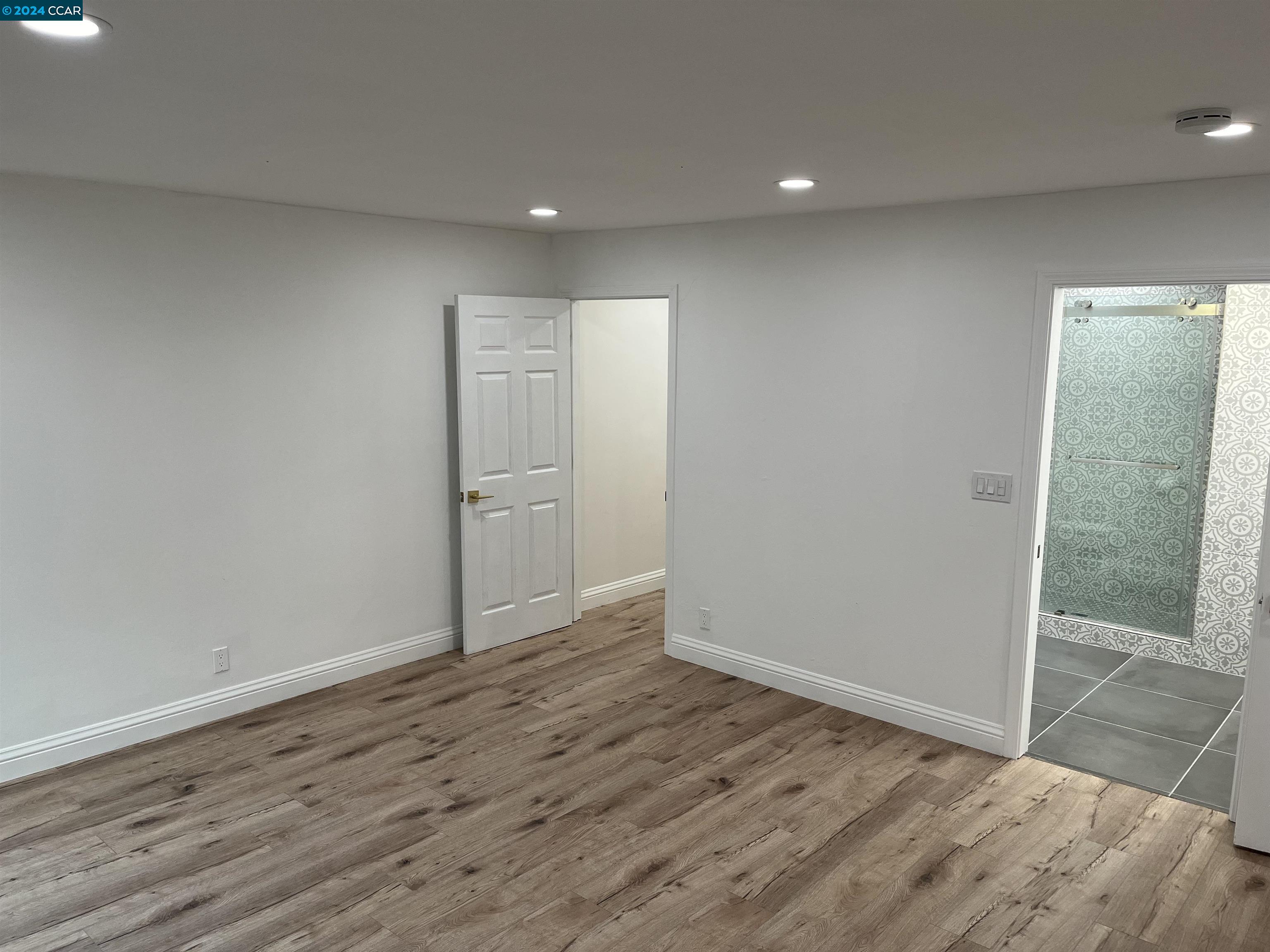 Glengarry Drive Walnut Creek, CA 94596 - Photo 12 of 21 an empty room with wooden floor and door