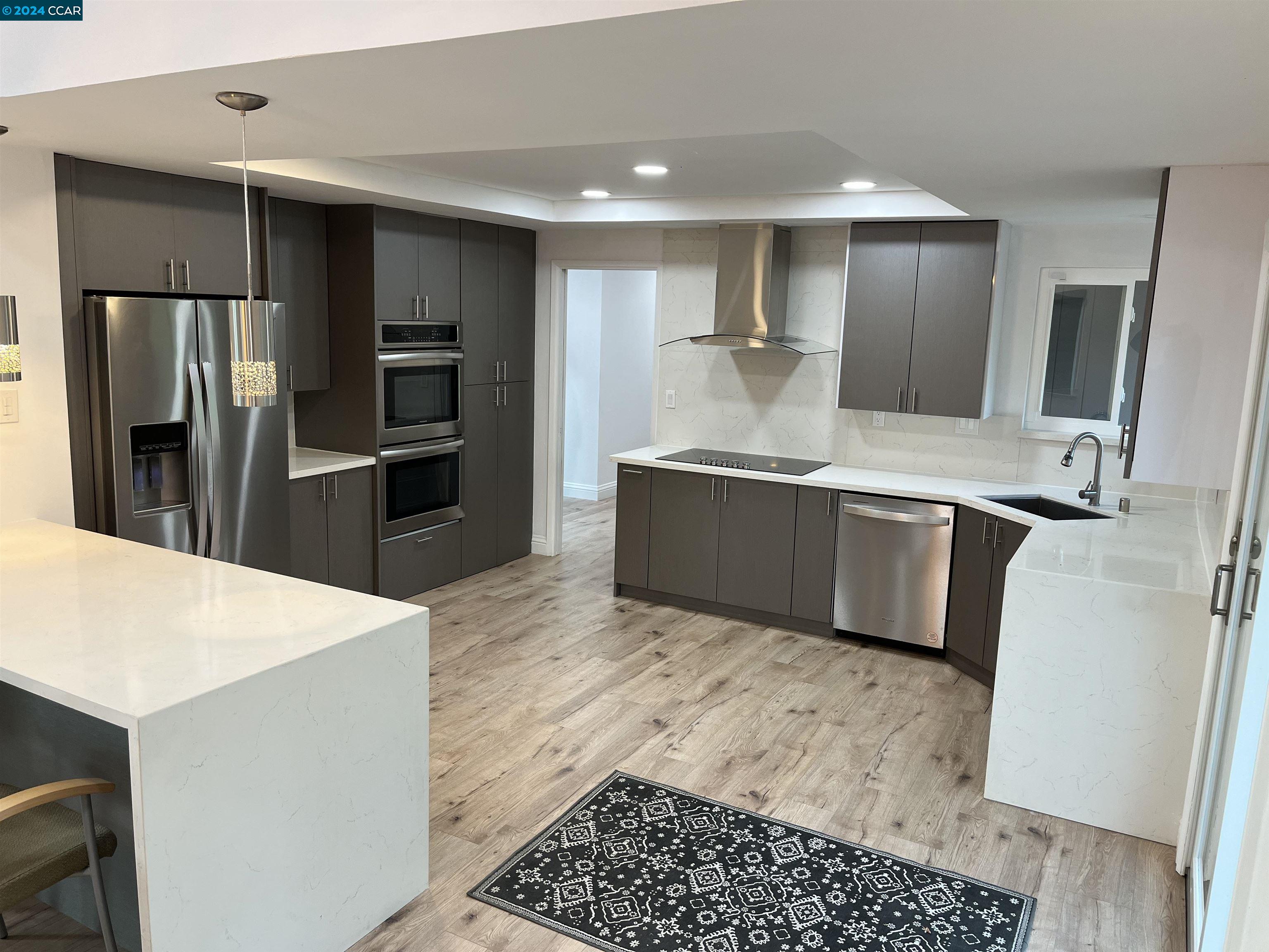 Glengarry Drive Walnut Creek, CA 94596 - Photo 7 of 21 a kitchen with stainless steel appliances kitchen island granite countertop a refrigerator and a sink