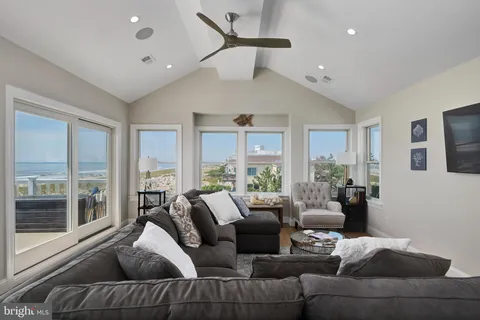 a living room with furniture wooden floor and a large window