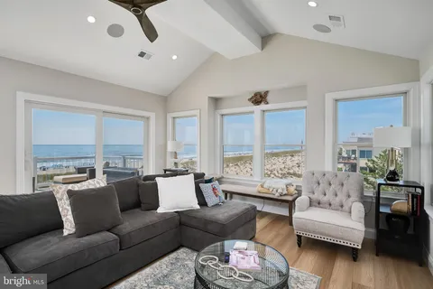 a living room with a couch and a floor to ceiling window