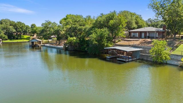 an aerial view of a house with swimming pool patio and outdoor seating