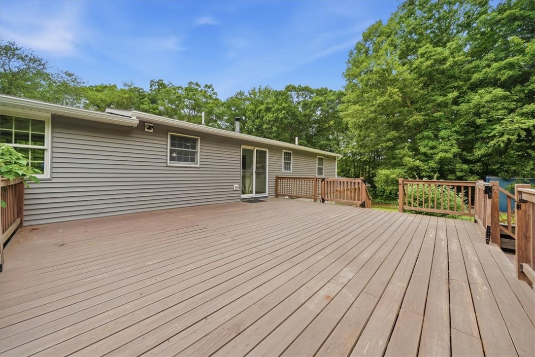 214 Anan Wade Road Glocester, RI 02857 - Photo 34 of 50 A standout feature is the deck’s three separate gated exits with sliding gates, offering both convenience and peace of mind for households with children or pets. One gate leads to the huge side yard, another heads toward the firepit and pool house, and the main gate leads directly down to the home’s incredible private pool and hot tub area.