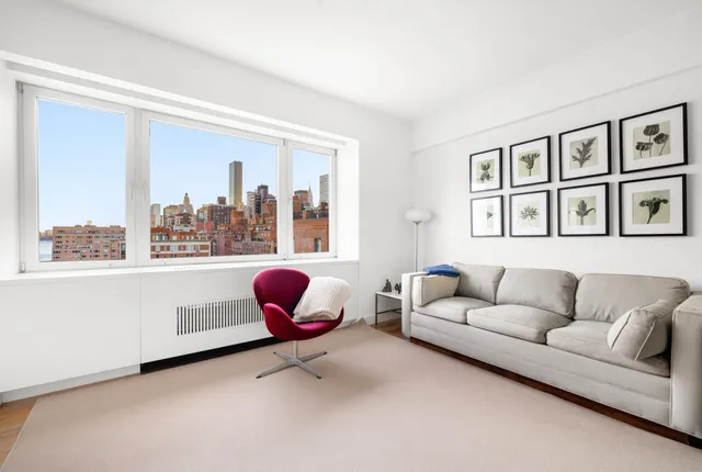 a living room with furniture and a book shelf