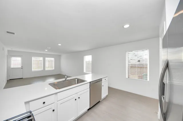 a view of a kitchen with a sink and a window