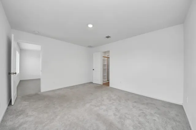 a view of a big house with a big yard and large trees