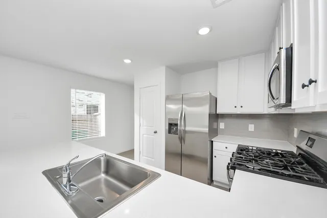 a view with a sink a window and a mirror