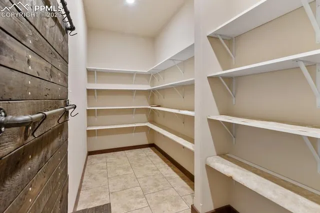 a living room with lots of furniture and kitchen view