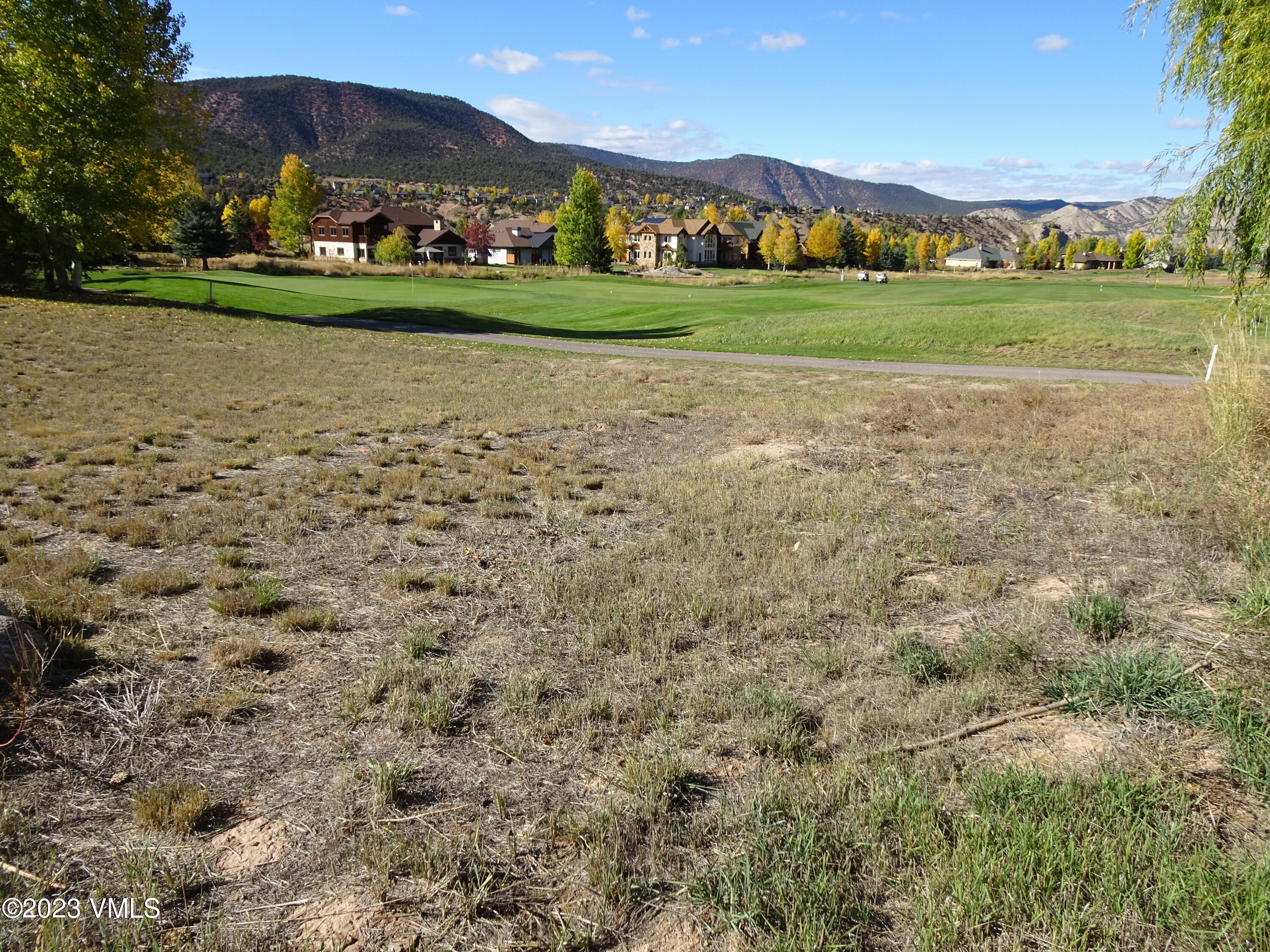a view of building with garden and trees