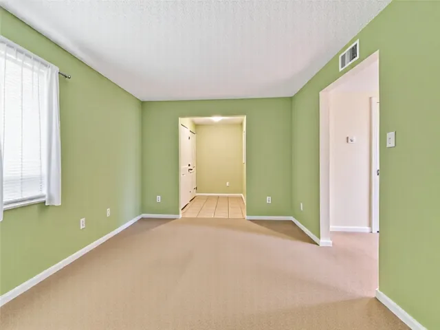 a living room with furniture a rug and a window