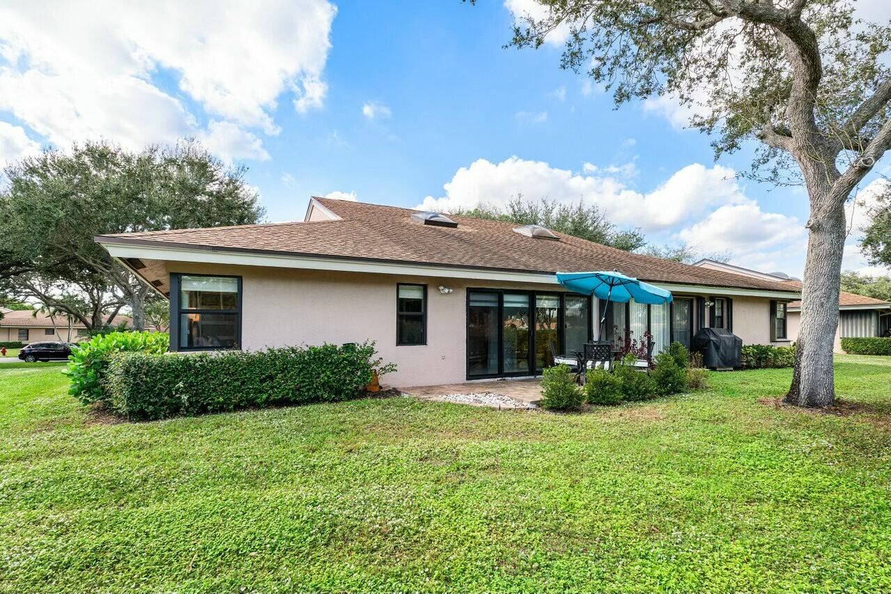 8211 Springlake Drive Boca Raton, FL 33496 - Photo 32 of 49 a front view of a house with garden